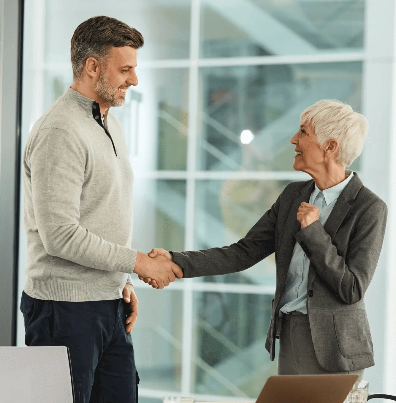 Smiling colleagues sealing a deal with handshake